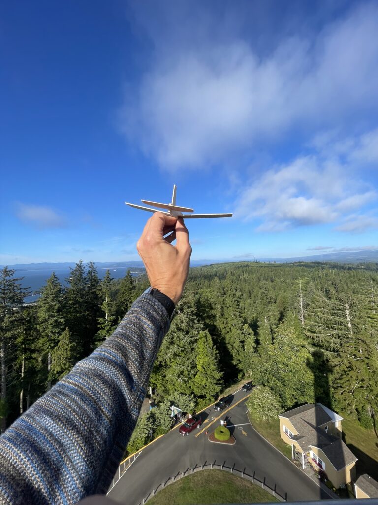 Throwing a wood glider off the top of the Astoria Column in Astoria, Oregon