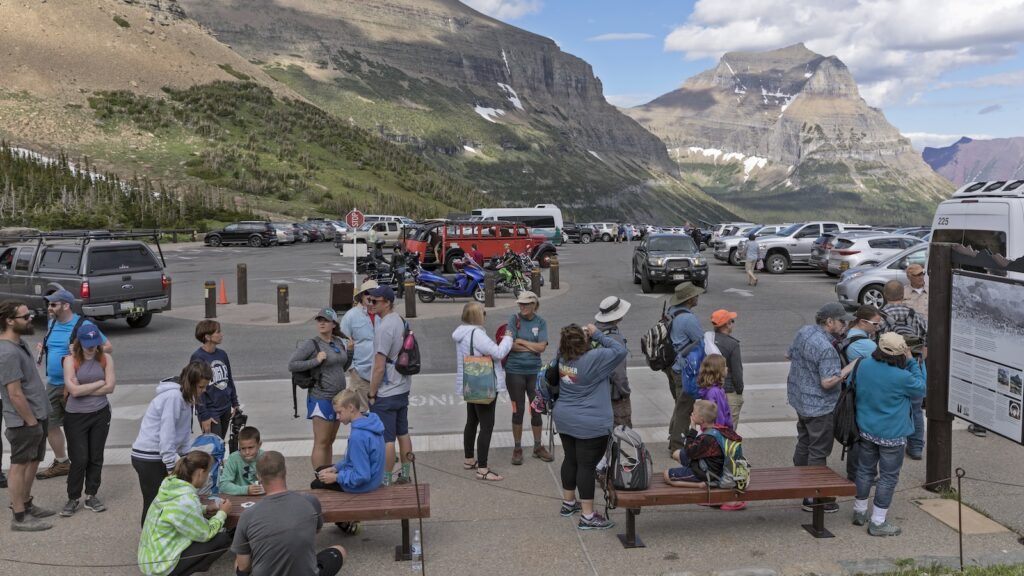 Tourists waiting to board the park shuttle at the bus stop