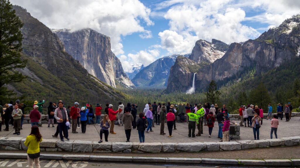People enjoying the great landscape with mountains and waterfalls at tunnel view in Yosemite National Park.