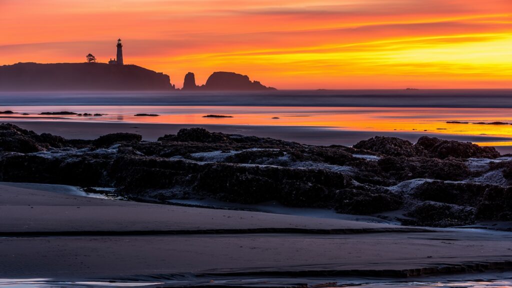 Dramatic sunset over the Yaquina Head Lighthouse in Newport, Oregon