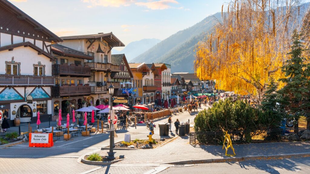 Autumn afternoon at the Bavarian themed village of Leavenworth, Washington, with themed sidewalk cafes and shops on the pedestrian main street.