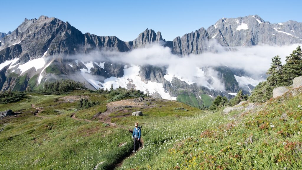 A Woman Hiker among Rocky Mountains on the Cascade Pass Sahale Arm Trail