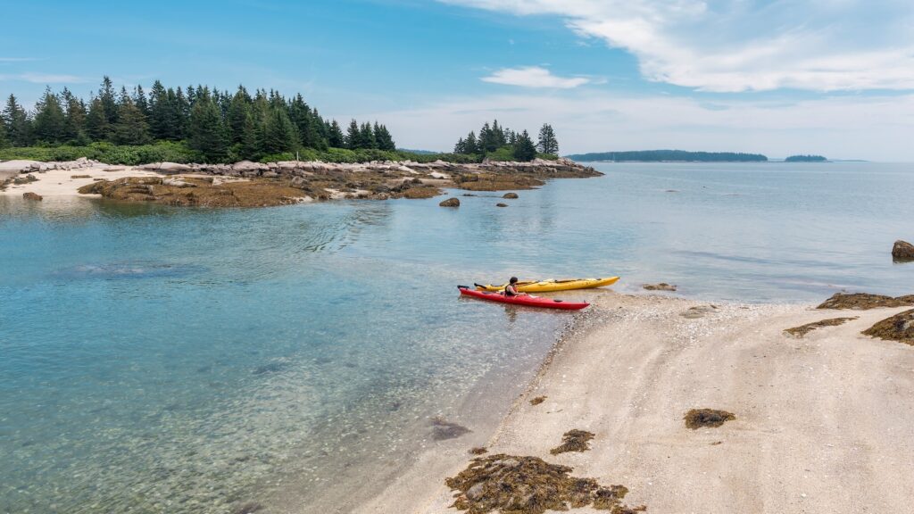 kayakers beached on the shore at Deer Isle, Maine